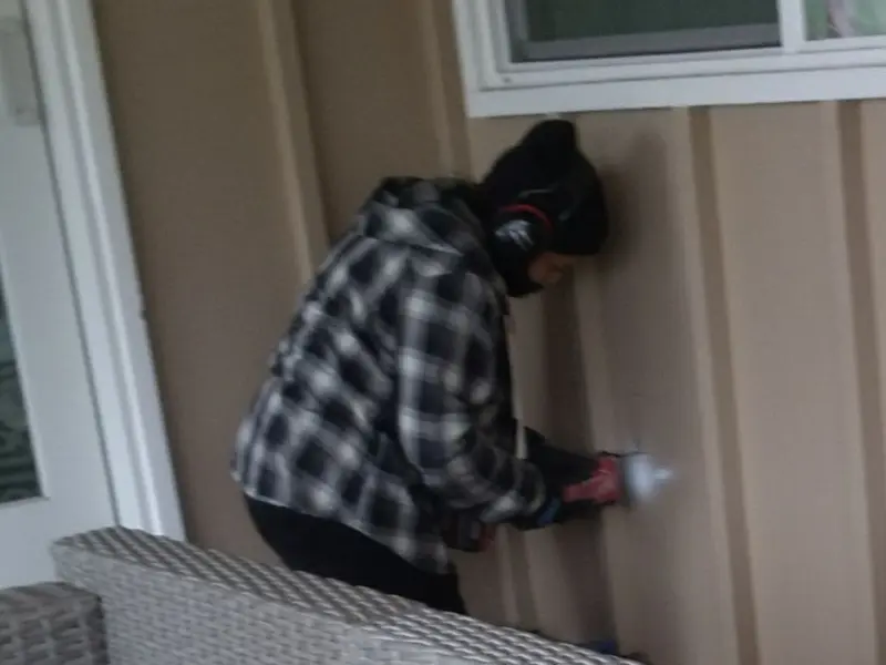 Professional electrician installing an exterior outlet in Palmyra